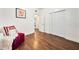 Bedroom with hardwood floors, a comfortable chair, and ample closet space at 908 Cannes Pl, Orlando, FL 32808
