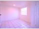 A clean, tile-floored bedroom featuring a window providing natural lighting at 908 Cannes Pl, Orlando, FL 32808