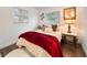 Cozy bedroom with a plush bed, soft lighting, and a decorative floral painting at 908 Cannes Pl, Orlando, FL 32808