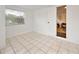 Bright room with tile flooring and a view to another room through an open door at 908 Cannes Pl, Orlando, FL 32808