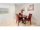 Dining room with a round table, three chairs and natural light from the window at 908 Cannes Pl, Orlando, FL 32808