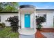 Charming home featuring a bright blue front door and manicured landscaping at 908 Cannes Pl, Orlando, FL 32808