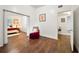Hallway featuring dark wood floors, with a view into the cozy bedroom with white walls at 908 Cannes Pl, Orlando, FL 32808