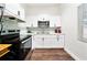 Modern kitchen with white cabinets, stainless steel appliances, and stylish backsplash at 908 Cannes Pl, Orlando, FL 32808