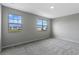Bright bedroom featuring plush carpeting, neutral paint and two large windows offering ample natural light at 9314 Bolshoi Aly, Winter Garden, FL 34787