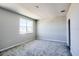 Bright bedroom featuring plush carpeting, neutral paint, and a large window offering ample natural light at 9314 Bolshoi Aly, Winter Garden, FL 34787