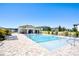 Community pool area with comfortable lounge chairs and clubhouse, ideal for relaxation at 9314 Bolshoi Aly, Winter Garden, FL 34787