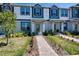 Charming townhome showcases a manicured lawn and welcoming walkway to the front entrance at 9314 Bolshoi Aly, Winter Garden, FL 34787