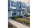 Attractive two-story townhome boasting a covered entry, well-manicured lawn, and tasteful exterior finishes at 9314 Bolshoi Aly, Winter Garden, FL 34787