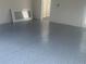 This is a clean and empty garage with a sink basin and a door to the rest of the house at 9314 Bolshoi Aly, Winter Garden, FL 34787