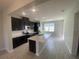 Modern kitchen with stainless steel appliances, spacious island, and dark cabinetry at 9314 Bolshoi Aly, Winter Garden, FL 34787