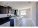 Modern kitchen with stainless steel appliances, spacious island, and dark cabinetry at 9314 Bolshoi Aly, Winter Garden, FL 34787