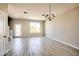 Open-concept living room featuring wood-look floors and a modern chandelier at 9314 Bolshoi Aly, Winter Garden, FL 34787