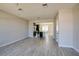 Open-concept living area with wood-look floors connecting to the kitchen at 9314 Bolshoi Aly, Winter Garden, FL 34787