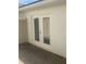 The double glass doors open onto a paved patio area, perfect for outdoor living at 9314 Bolshoi Aly, Winter Garden, FL 34787