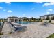 Community pool surrounded by lounge chairs and verdant landscaping on a clear day at 9314 Bolshoi Aly, Winter Garden, FL 34787