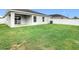 A partially fenced backyard area with ample grass, perfect for entertaining or enjoying outdoor living at 405 Bandon Dunes Loop, Davenport, FL 33837