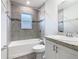 Bathroom featuring a neutral tile surround, a vanity sink, and a bath-shower combo at 405 Bandon Dunes Loop, Davenport, FL 33837