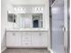 Bright bathroom with a double sink vanity, modern lighting, and glass shower at 405 Bandon Dunes Loop, Davenport, FL 33837