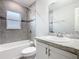 Neutral bathroom features a shower-tub combo with tile surround and vanity sink at 405 Bandon Dunes Loop, Davenport, FL 33837