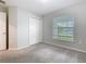 Bright bedroom featuring a closet, window with blinds, and neutral carpeting at 405 Bandon Dunes Loop, Davenport, FL 33837