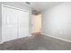 Neutral bedroom with a double door closet, carpeted floor, and connecting doorway at 405 Bandon Dunes Loop, Davenport, FL 33837