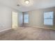 Bright bedroom with neutral walls and carpet featuring large windows at 405 Bandon Dunes Loop, Davenport, FL 33837