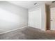 Cozy bedroom featuring neutral paint, plush carpeting, and closet with paneled doors at 405 Bandon Dunes Loop, Davenport, FL 33837