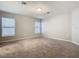 Sunny bedroom featuring neutral carpet and walls, with large double windows at 405 Bandon Dunes Loop, Davenport, FL 33837
