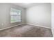 Neutral bedroom featuring a carpet and window, perfect for relaxation and rest at 405 Bandon Dunes Loop, Davenport, FL 33837