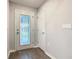 The foyer features wood-look flooring and a door with glass inset that provides natural light at 405 Bandon Dunes Loop, Davenport, FL 33837