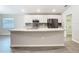 Island kitchen with stone countertops, stainless steel appliances, and lots of cabinet space at 405 Bandon Dunes Loop, Davenport, FL 33837