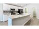 Kitchen with modern appliances, stone countertops, and convenient sink island at 405 Bandon Dunes Loop, Davenport, FL 33837