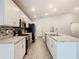 Bright, well-equipped kitchen with white cabinets, granite countertops, stainless appliances, and tile backsplash at 405 Bandon Dunes Loop, Davenport, FL 33837