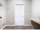Laundry room with white door, wire rack shelving, and counter with granite look top at 405 Bandon Dunes Loop, Davenport, FL 33837