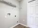 Laundry room with white door, wire rack shelving, and wood-look flooring at 405 Bandon Dunes Loop, Davenport, FL 33837