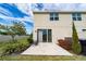 Rear exterior view of the home highlighting the patio and a well maintained backyard at 10849 Wyne Tree Ct, Orlando, FL 32824