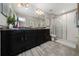 Bathroom featuring double sinks, black cabinets with gold hardware, and a glass-enclosed shower at 10849 Wyne Tree Ct, Orlando, FL 32824