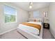 Bedroom with natural light, soft carpet, modern décor, and a window view, promoting relaxation at 10849 Wyne Tree Ct, Orlando, FL 32824