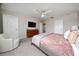 Cozy bedroom with a ceiling fan, soft carpet, and a mounted flatscreen television at 10849 Wyne Tree Ct, Orlando, FL 32824