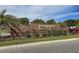 Brick sign for Woodland Park featuring manicured landscaping on a sunny day at 10849 Wyne Tree Ct, Orlando, FL 32824