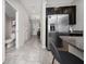 Hallway view featuring a staircase, stainless steel refrigerator, and a granite countertop at 10849 Wyne Tree Ct, Orlando, FL 32824