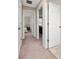 Hallway with carpet, leading to various rooms, offering a glimpse of bedroom interior at 10849 Wyne Tree Ct, Orlando, FL 32824