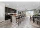 Open concept kitchen with granite countertops, dark cabinets, and seating at the island at 10849 Wyne Tree Ct, Orlando, FL 32824