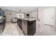 Kitchen featuring a granite countertop island and stainless steel appliances in an open concept layout at 10849 Wyne Tree Ct, Orlando, FL 32824