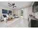 Bright living room with tile floors, modern decor, and sliding glass doors to the backyard at 10849 Wyne Tree Ct, Orlando, FL 32824