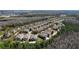 Aerial view of a neighborhood showing rows of houses, streets, and a forested area at 10876 Eclipse Lily Way # 60, Orlando, FL 32832