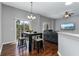 Bright dining area with hardwood floors and sliders to the balcony for outdoor enjoyment at 10876 Eclipse Lily Way # 60, Orlando, FL 32832