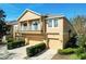 Two-story townhome showcasing its charming architecture, private balconies, and manicured landscaping, under a clear, sunny sky at 10876 Eclipse Lily Way # 60, Orlando, FL 32832