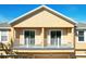 Home exterior featuring two balconies and neutral colored stucco and trim under a bright blue sky at 10876 Eclipse Lily Way # 60, Orlando, FL 32832